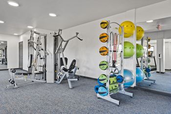 a gym with weights and other exercise equipment in a building